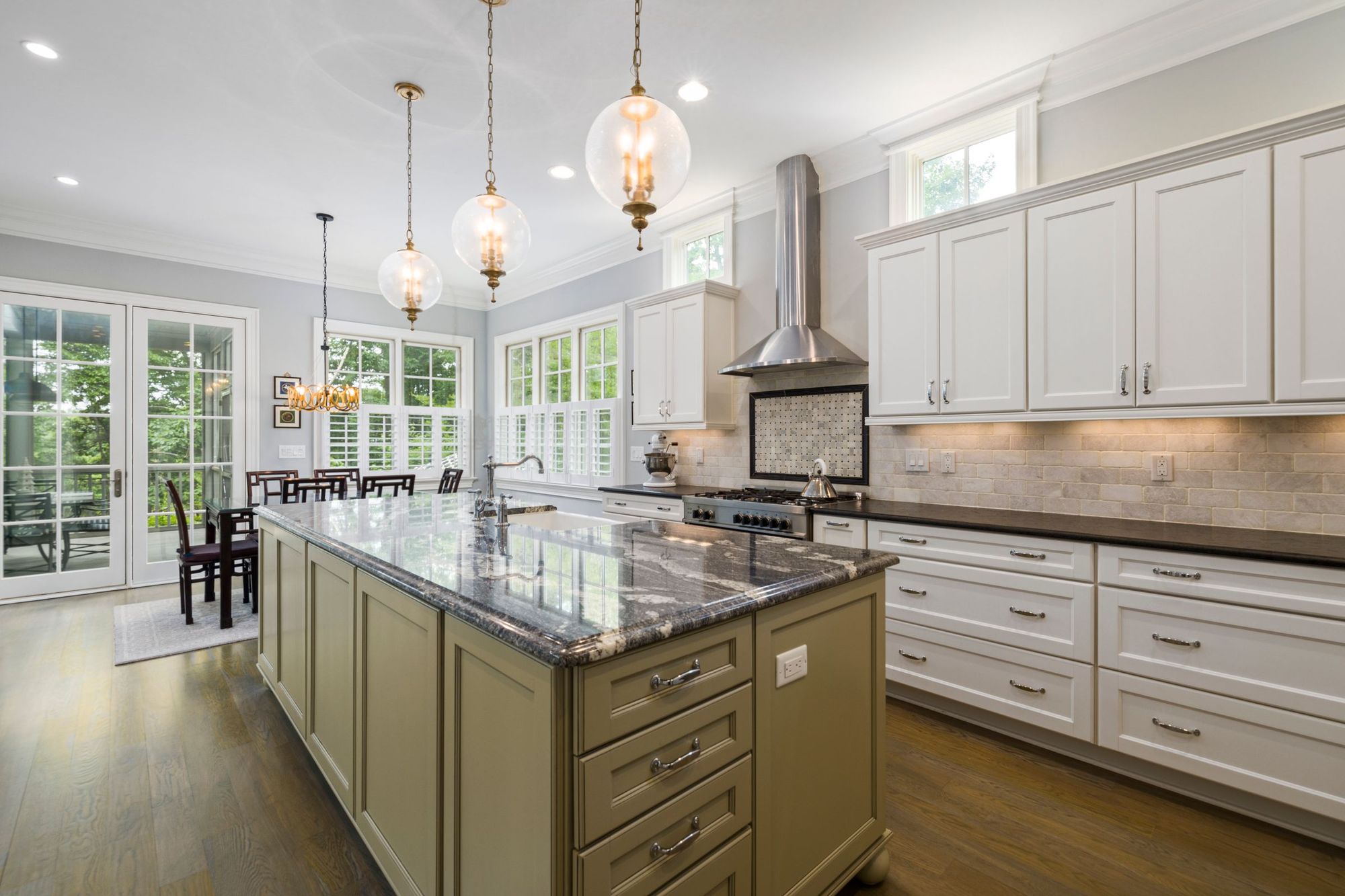 Classic kitchen with an olive island and lantern pendants
