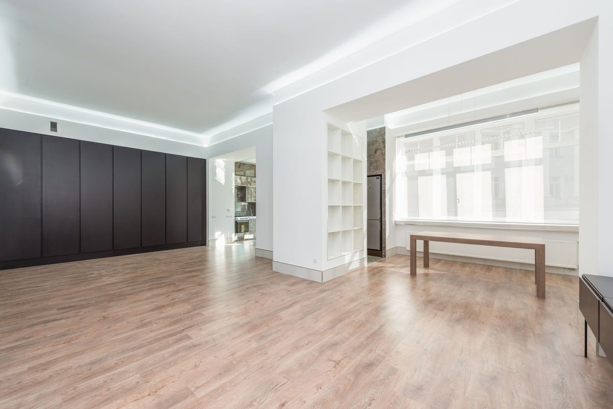 Empty modern room with a long window and pale wood floors