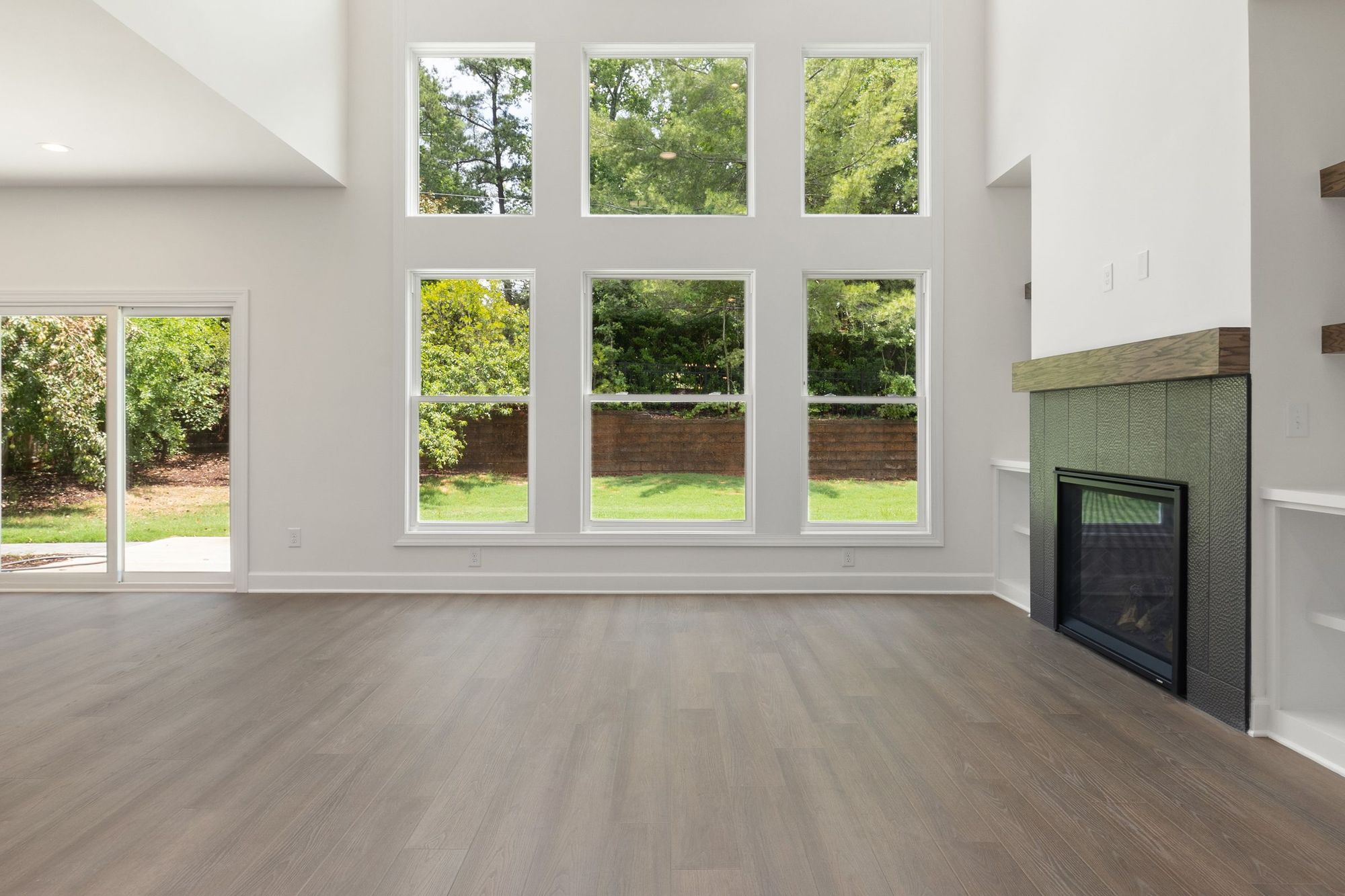 Two-story room with tall windows and a fireplace