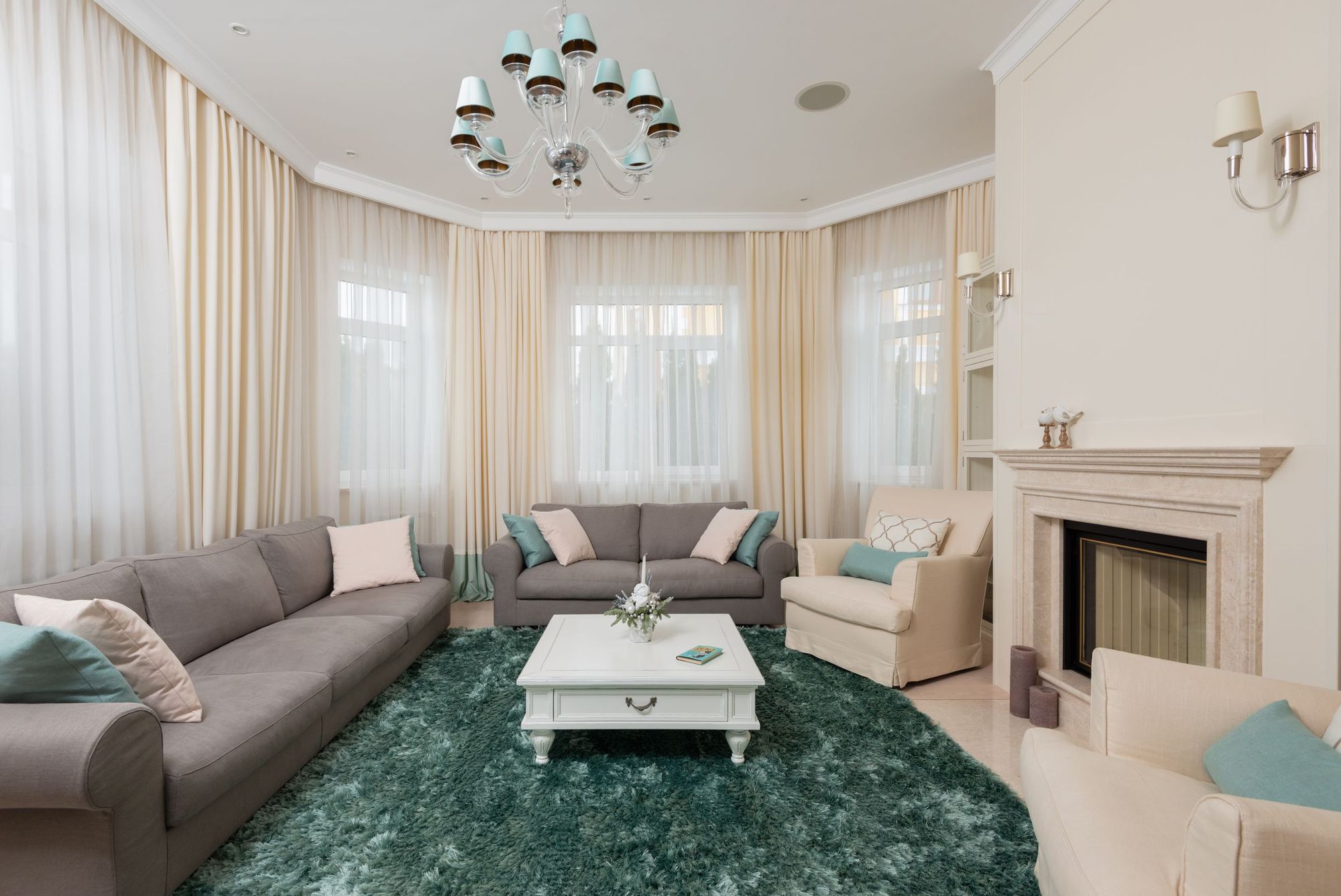 Living room with a plush rug, deep sofa and fireplace